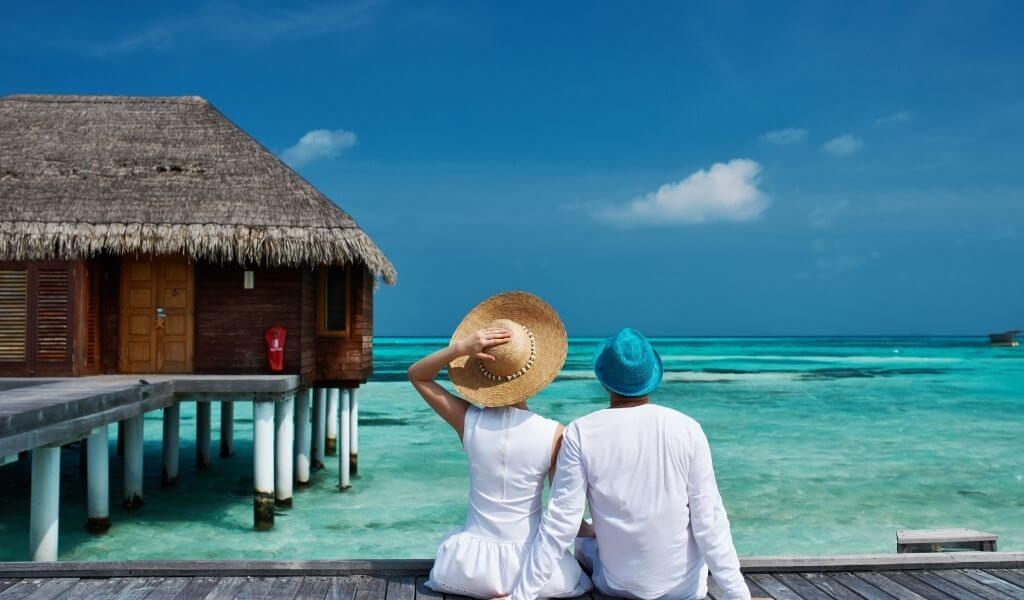 couple relaxing in one of many luxury resorts in Maldives during honeymoon tours