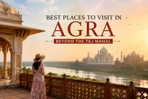 Scenic view of the Taj Mahal across the Yamuna River from a Mughal-style viewpoint in Agra