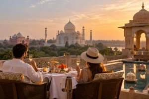 Luxury India private tour featuring a couple enjoying a private dining experience overlooking the Taj Mahal at sunset.